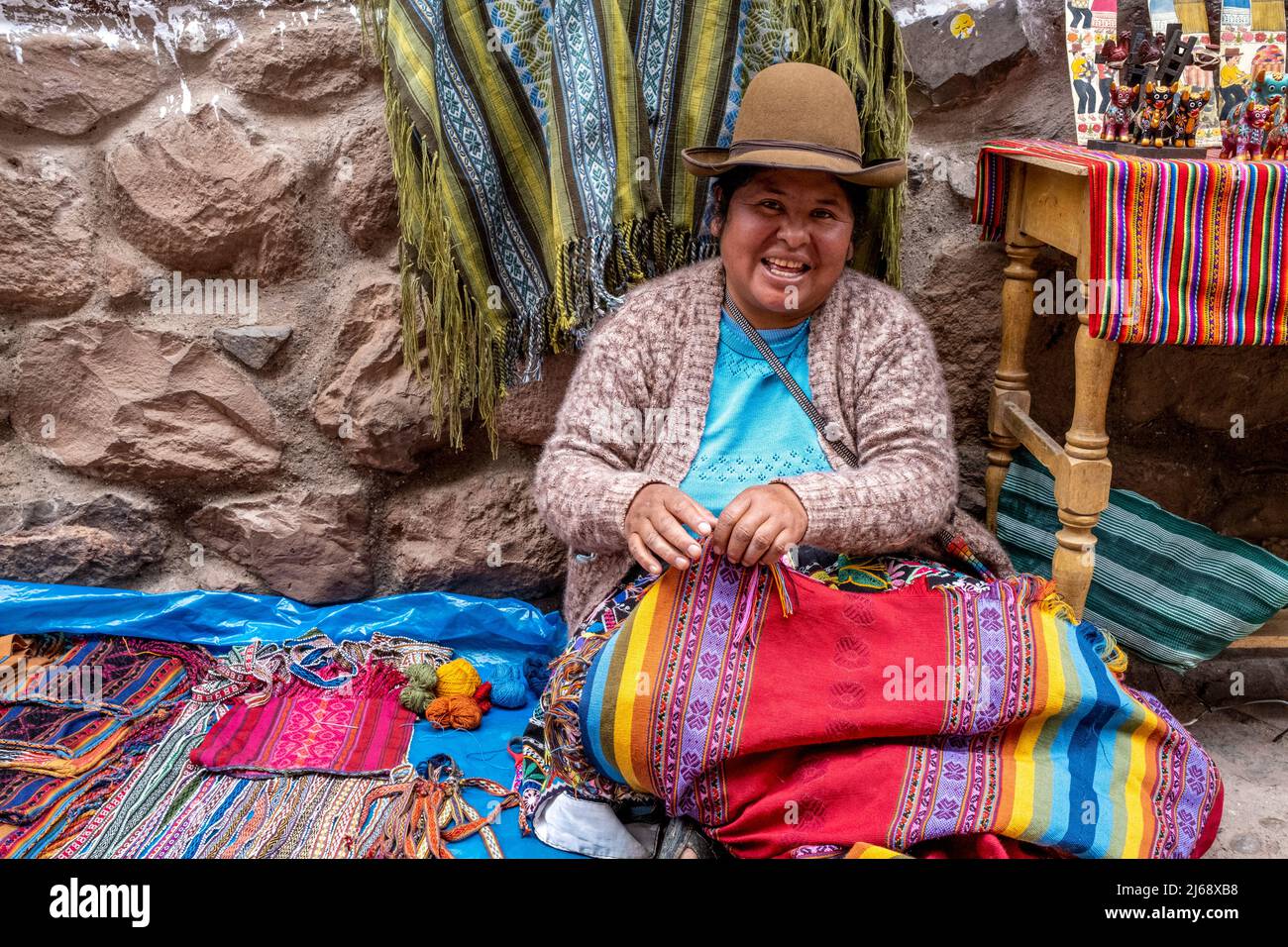 Una donna indigena mostra i suoi souvenir fatti a mano / artigianato al mercato Domenica nella città di Pisac, la Valle Sacra, provincia di Calca, Perù. Foto Stock