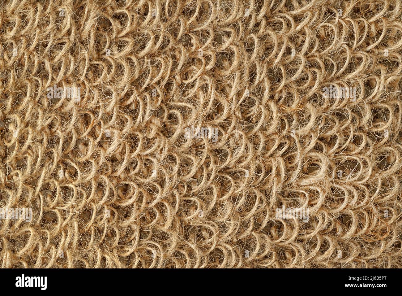 Washcloth di iuta da vicino per texture e sfondo. Superficie ruvida realizzata con anelli di corda ruvidi Foto Stock