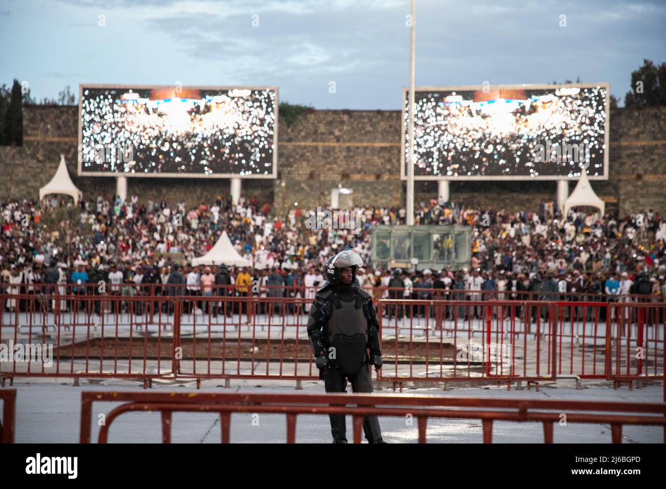 (220430) -- ADDIS ABEBA, 30 aprile 2022 (Xinhua) -- un ufficiale di polizia si leva come devoti frequenta una strada Iftar per rompere il digiuno del mese santo islamico di Ramadan a Piazza Meskel ad Addis Abeba, Etiopia, il 29 aprile 2022. (Xinhua/Michael Tewelde) Foto Stock