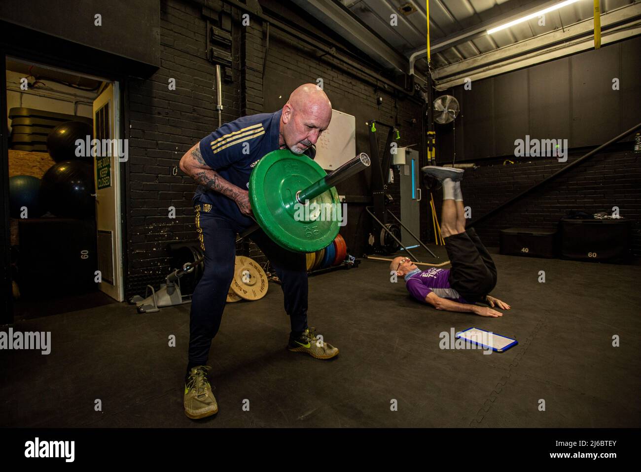 Uomo sollevamento pesi in palestra , West Yorkshire, Inghilterra. Foto Stock