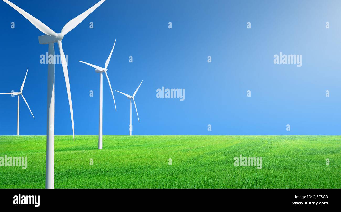 File di generatori di vento su un campo di erba verde contro il cielo blu. Panorama paesaggistico minimalista con spazio di copia Foto Stock