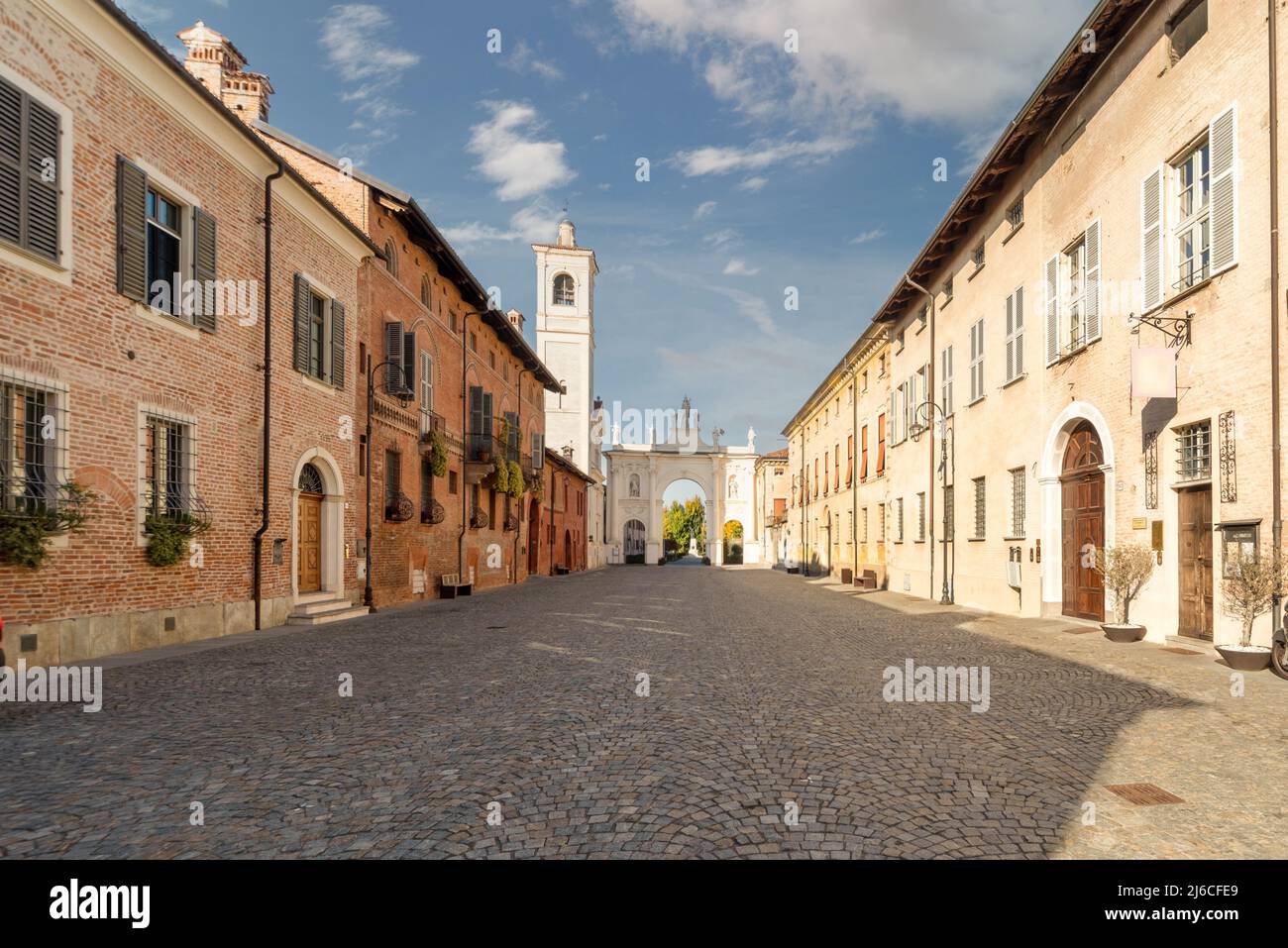 Cherasco, Cuneo, Italia - 27 ottobre 2021: Via Vittorio Emanuele II con gli edifici storici e l'Arco di Belvedere sullo sfondo, strada principale o Foto Stock