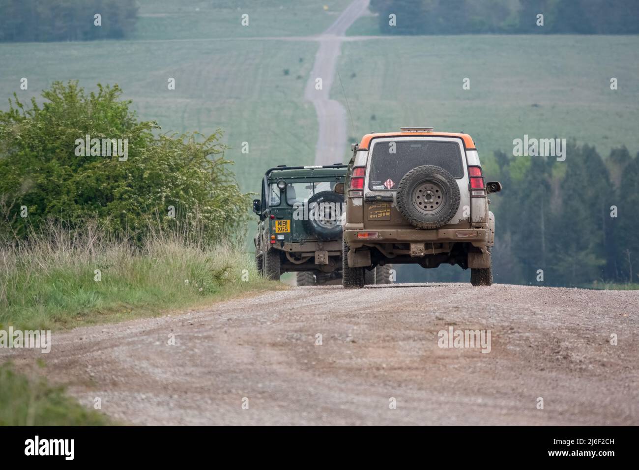 La Discovery 4x4 Land rover serie II segue un Land Rover Defender SWB su una pista in pietra per la guida fuoristrada Foto Stock