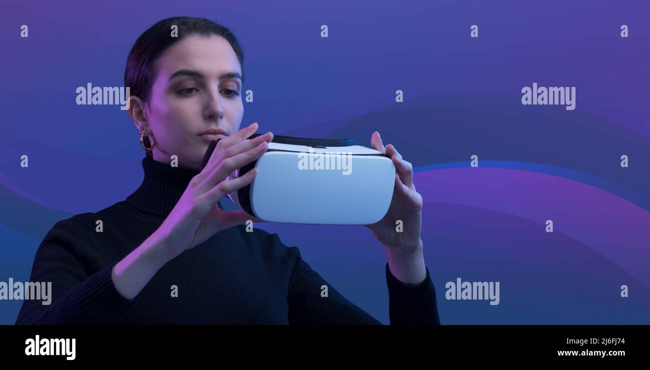 Giovane donna che indossa un visore VR, realtà virtuale e un concetto di metaverse Foto Stock