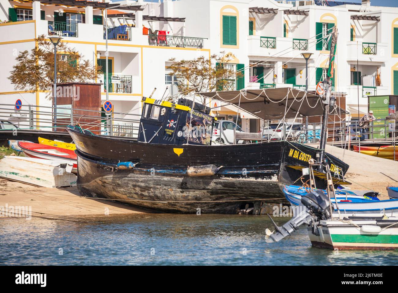 Barca da pesca ancorata a riva nel villaggio di Cabanas nel mezzo della riserva naturale Ria Farmosa nell'Algarve, Portogallo Foto Stock