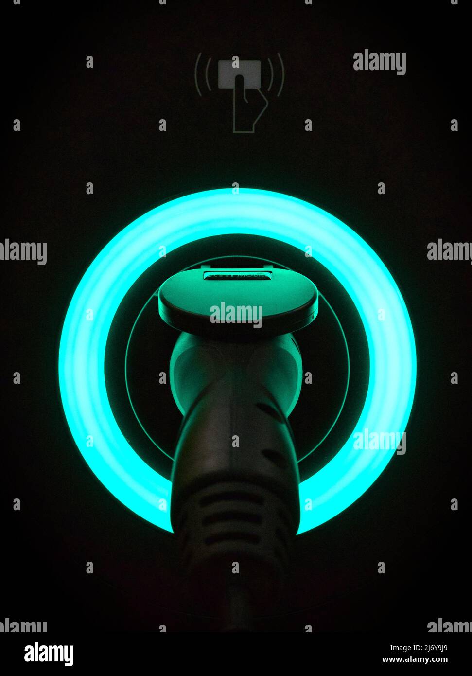 Un caricabatteria per la casa del veicolo elettrico (EV) di tipo 2, 7kW nero con un anello LED blu che indica lo stato: 'In carica'. Con lettore di schede RFID senza contatto. Foto Stock