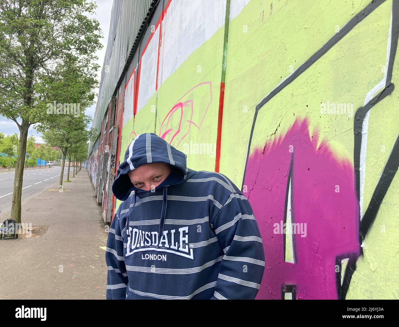 04 maggio 2022, Gran Bretagna, Belfast: Connor, 35, artista graffiti di Belfast si trova di fronte ad un muro dipinto. La Gran Bretagna elegge nuovi consigli locali e distrettuali. Per i Tories, scandalosi, del primo ministro Boris Johnson, ciò potrebbe essere spiacevole. (A dpa 'portent per Johnson? Elezioni regionali e locali in Gran Bretagna') Foto: Christoph Meyer/dpa Foto Stock