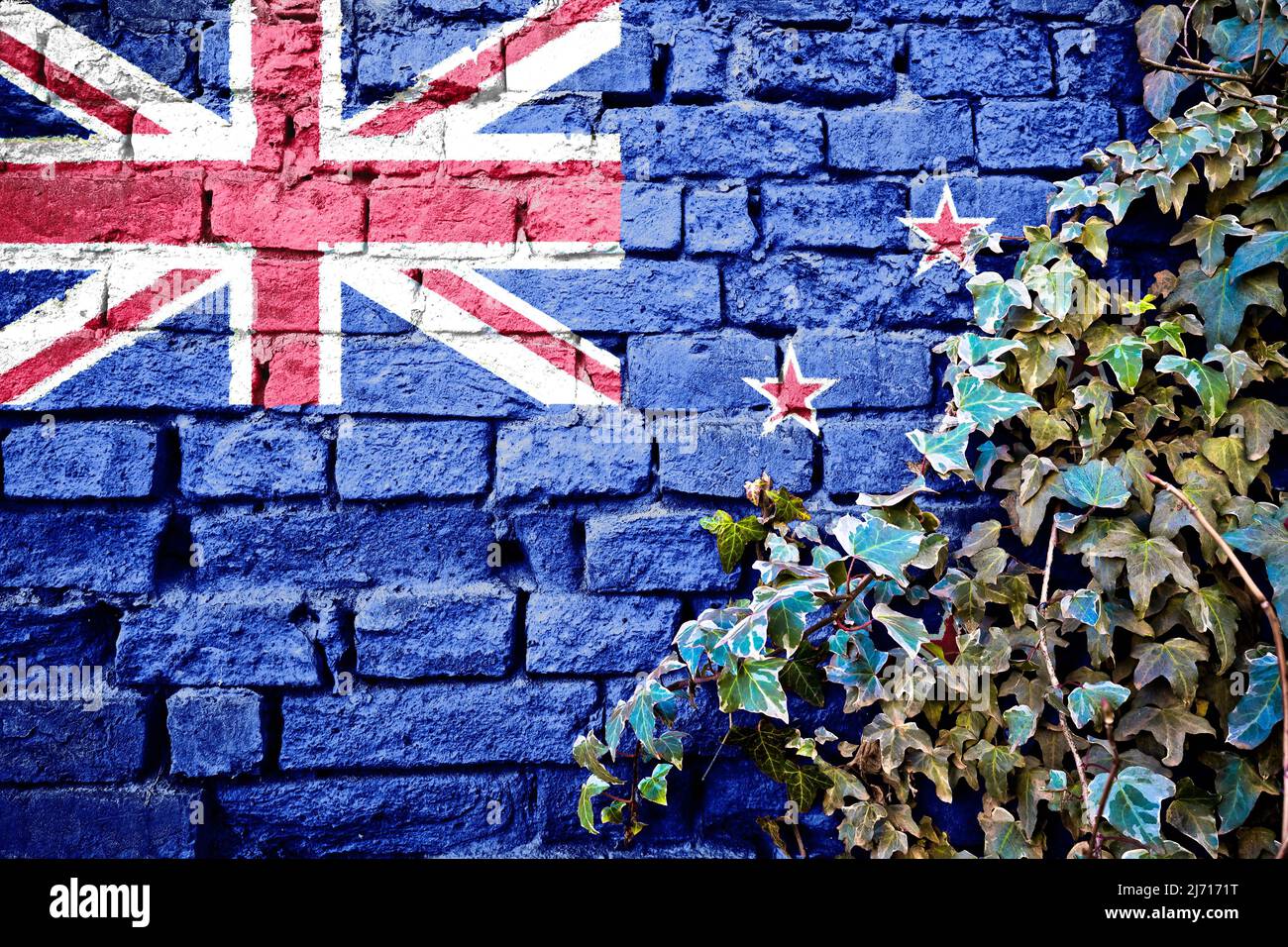 Nuova bandiera zeland grunge su muro di mattoni con pianta di edera, simbolo di paese concetto Foto Stock
