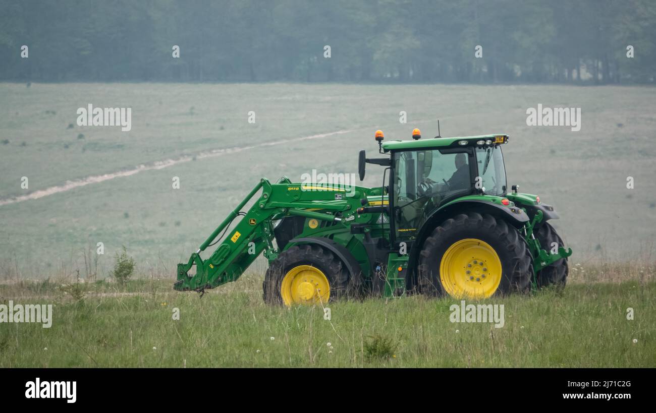 Trattore agricolo John Deere 6215R in movimento con sollevatore anteriore Foto Stock
