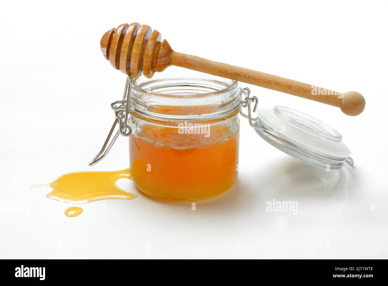 Bienenhonig in Glas und Honigloeffel, Bluetenhonig Foto Stock