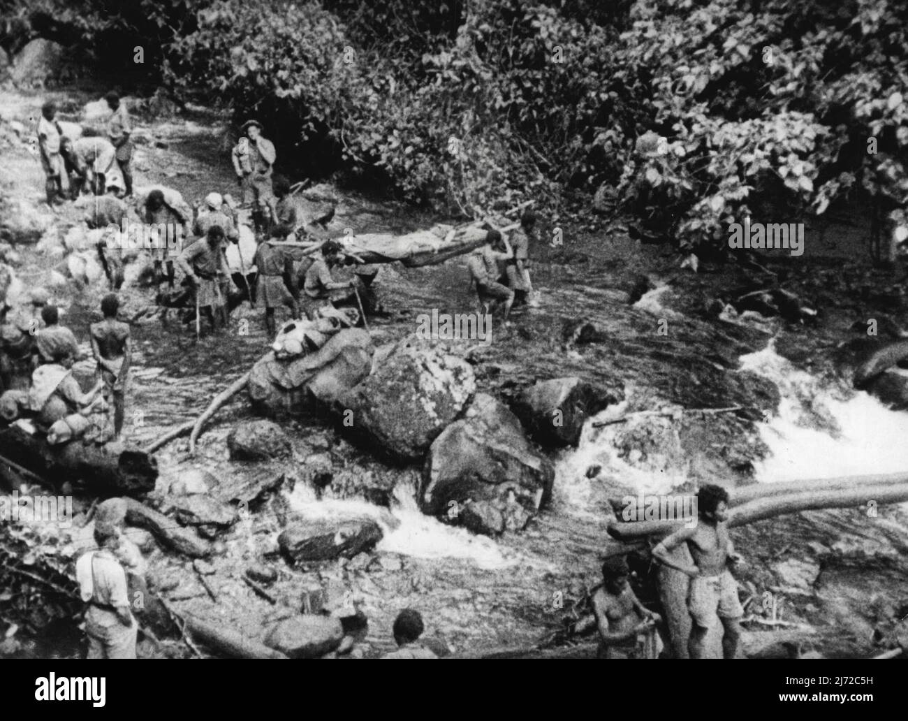 I feriti australiani sono stati effettuati da portarelle in Nuova Guinea nelle zone di andata. Questa è una scena del film -'Sons of the Anzacs' che verrà proiettato al Municipio, a partire da domani sera. Tiri effettivi da Tobruk, Malaya, Darwin. Bismarck Sea e Kokoda sono insieme per realizzare questo film epico. Sono stati presi dal cameramen ufficiale dell'asso dell'Australia, compreso Damien Parer e il capitano Frank Hurley. Il commento è di Chester wilmot. Novembre 18, 1943. Foto Stock