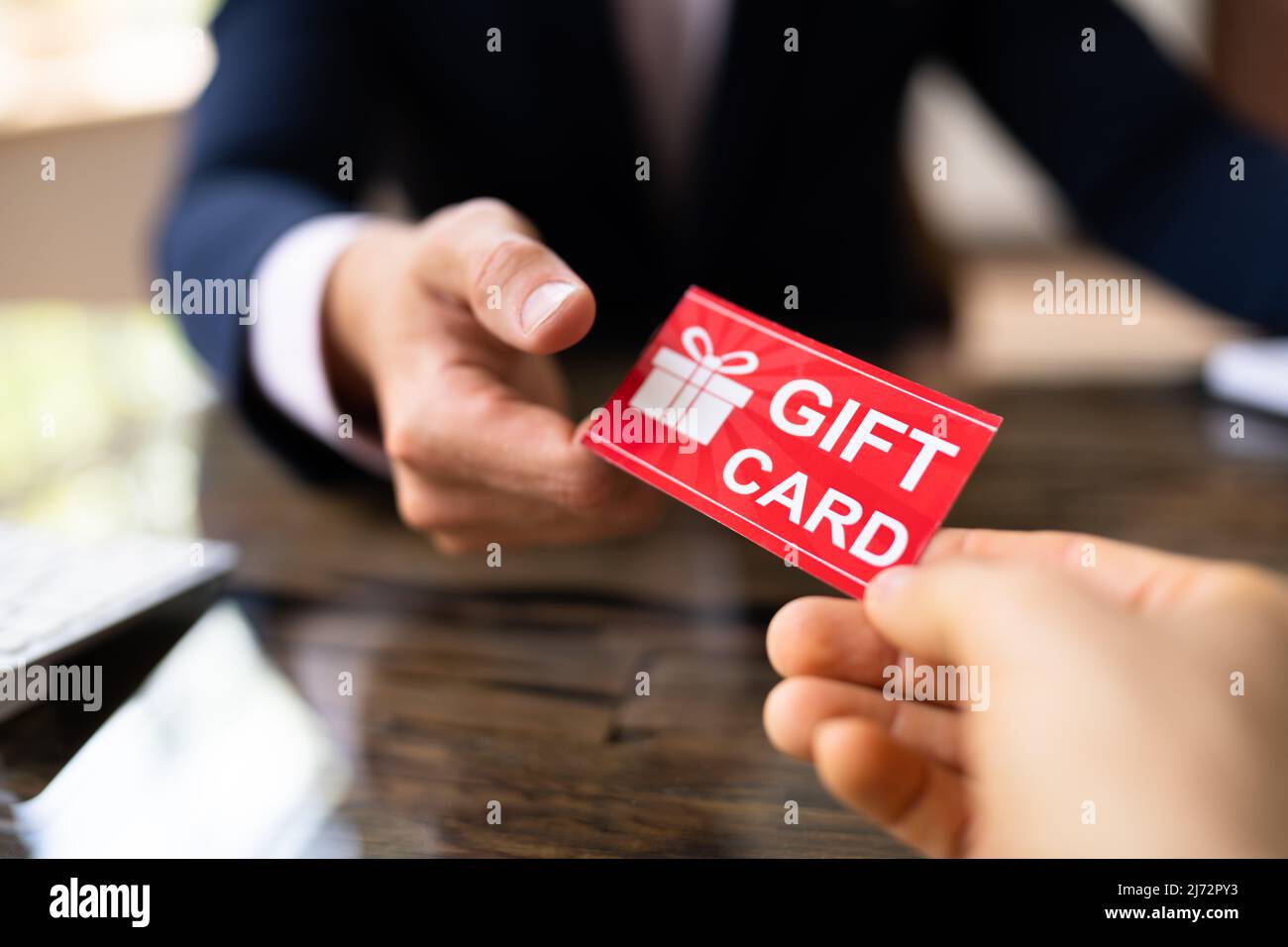 Tenere in mano il voucher e il biglietto della carta regalo Foto Stock
