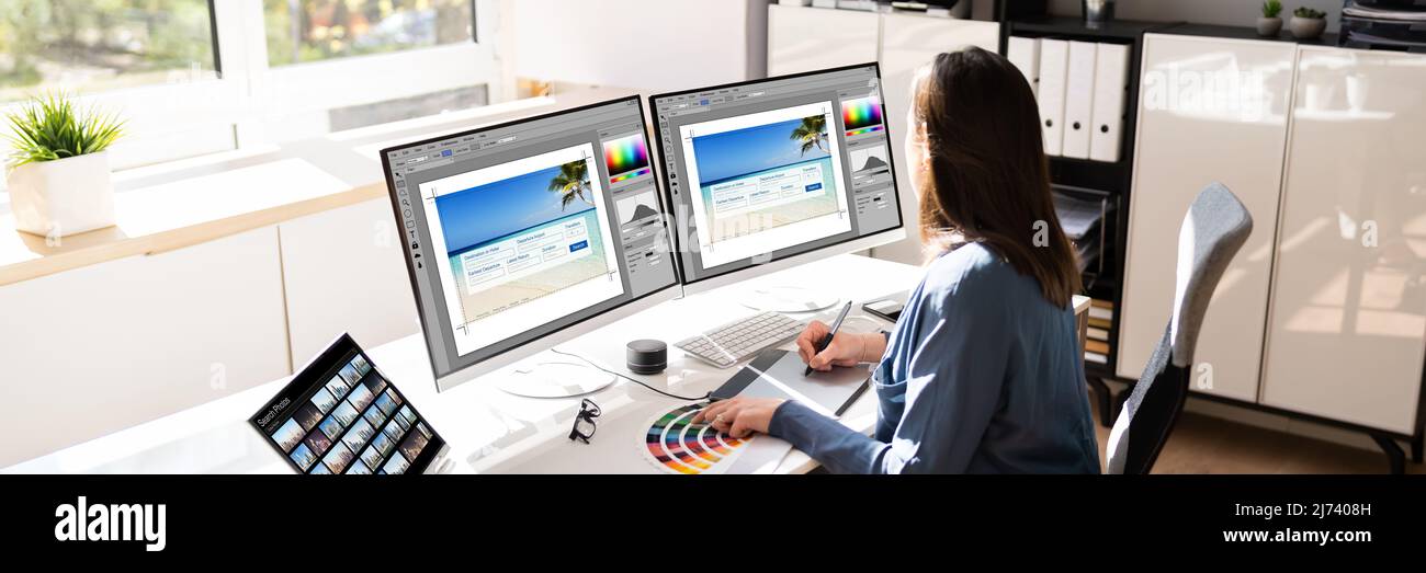 Graphic Web Designer che utilizza più monitor computer desktop Foto Stock