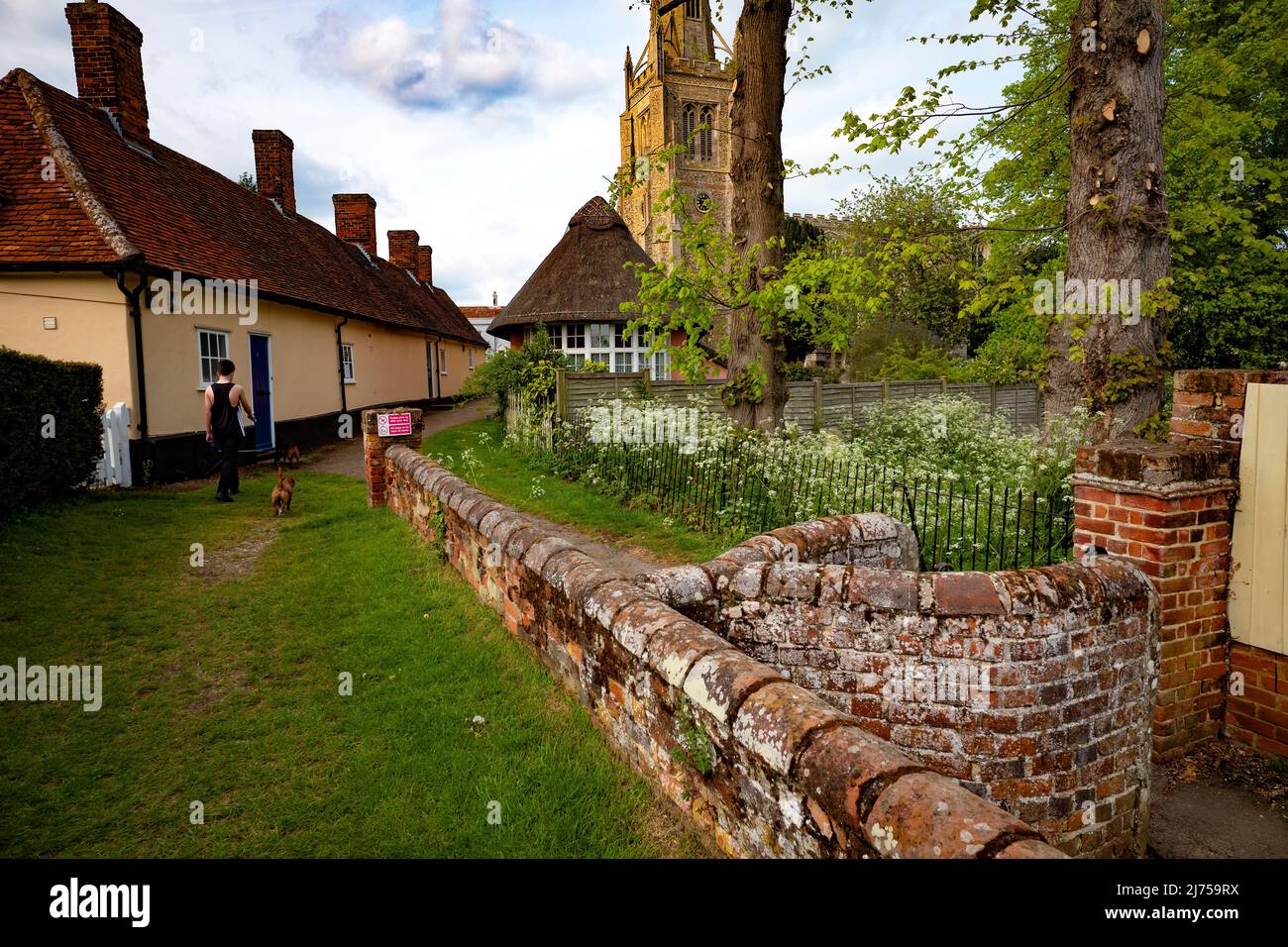 Thaxted Essex Inghilterra UK Maggio 2022 Chiesa di Thaxted con case ALMS a sinistra visto dall'antica porta Kissing Foto Stock