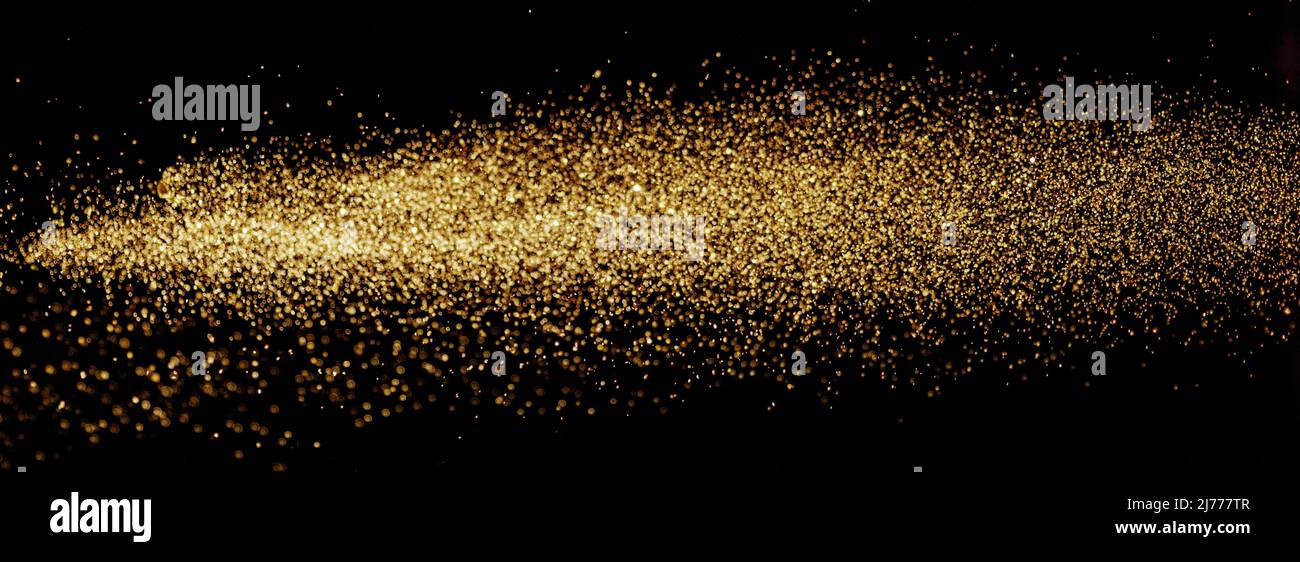 Luci dorate con glitter su sfondo nero. Foto Stock