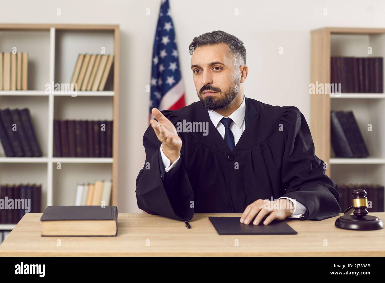 Ritratto di un giovane giudice americano in abito durante un processo in tribunale in aula Foto Stock