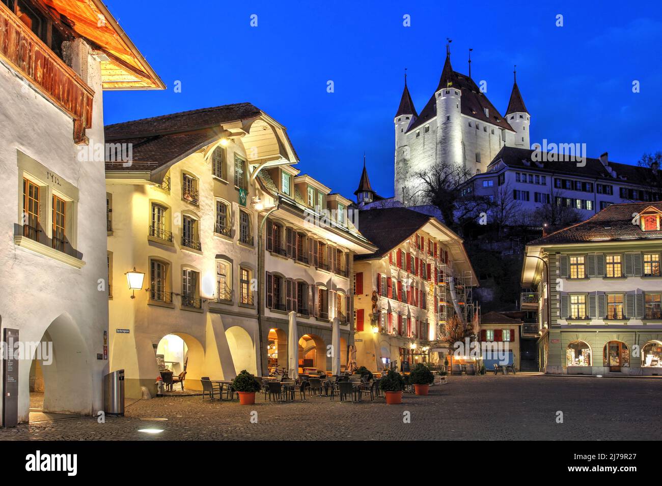 Rathausplatz (Piazza del Municipio) a Thun, Canton Berna, Svizzera di notte, con il bianco tino del Castello di Thun che domina la scena Foto Stock