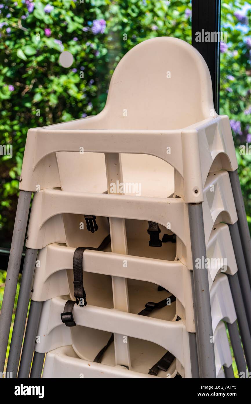 Pila di seggioloni in plastica per bambini nel bar Foto Stock