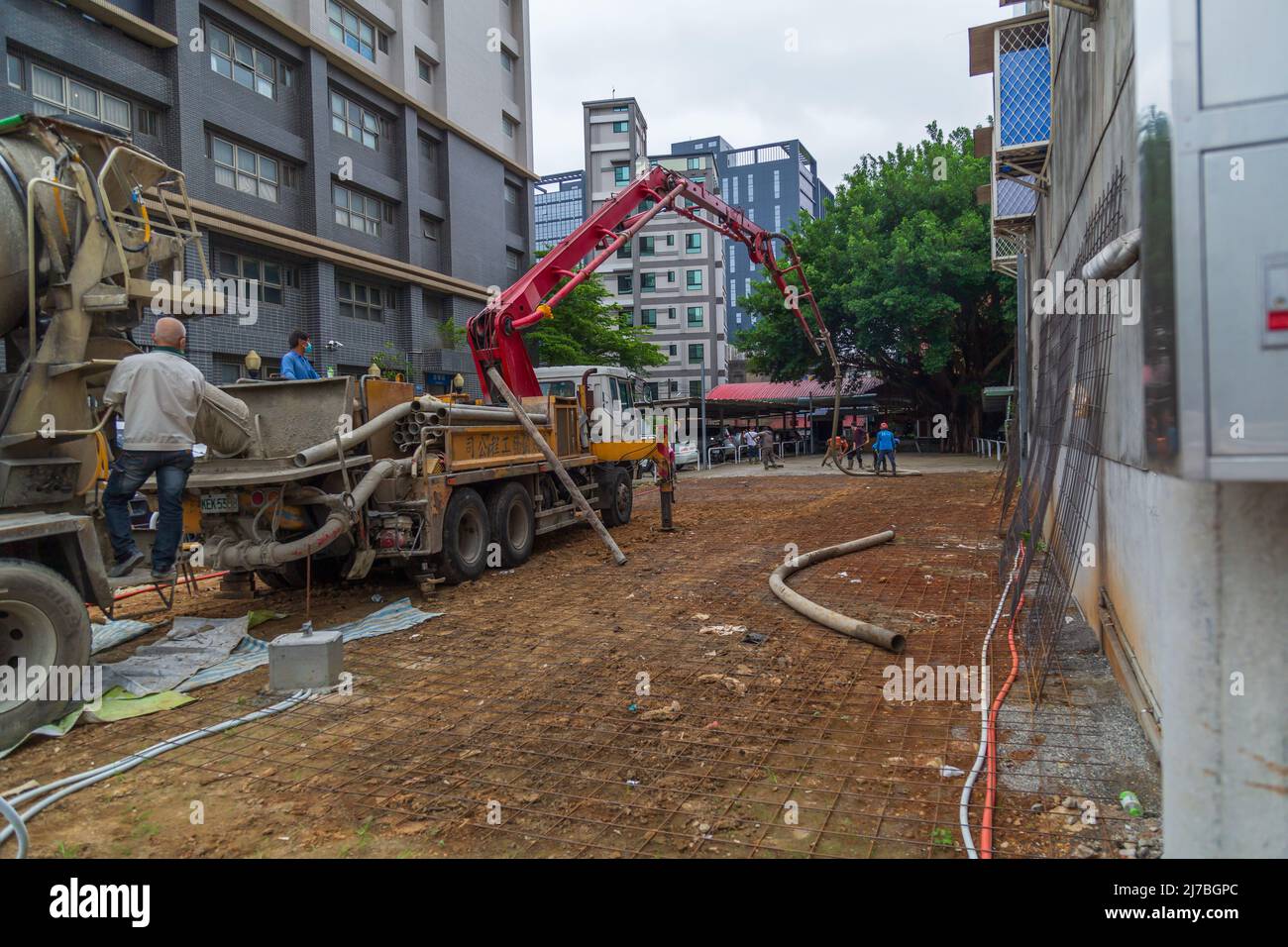 Lavoratori che posano cemento per lavori di costruzione. Foto Stock