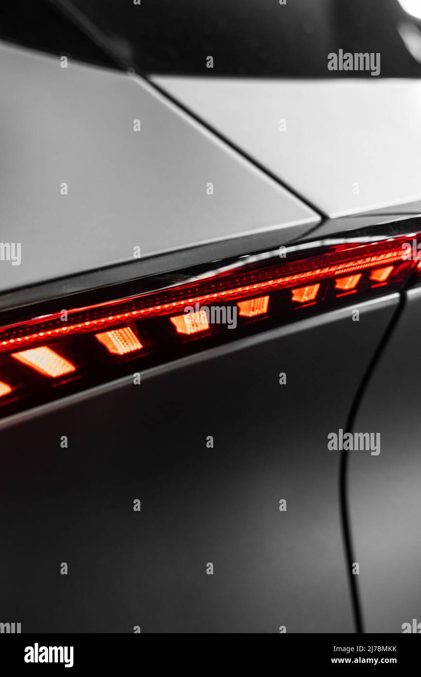 struttura in metallo opaco ultramoderno con forme curve e una plastica rossa con luce da dietro con un'atmosfera futuristica Foto Stock