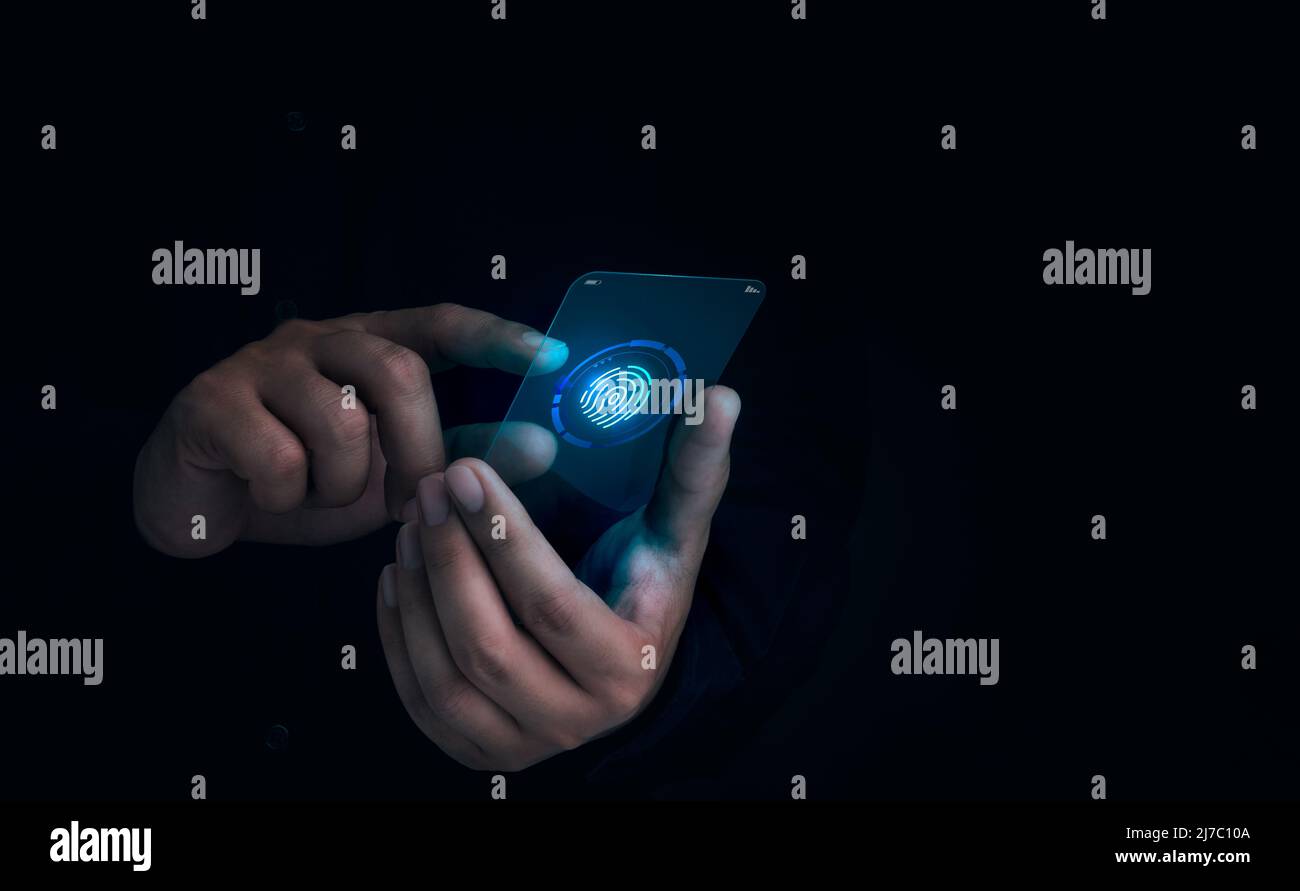 L'icona di scansione delle dita è apparsa mentre il dito dell'uomo è toccato sul futuristico telefono cellulare in vetro trasparente su sfondo scuro. Sicurezza informatica, data prote Foto Stock