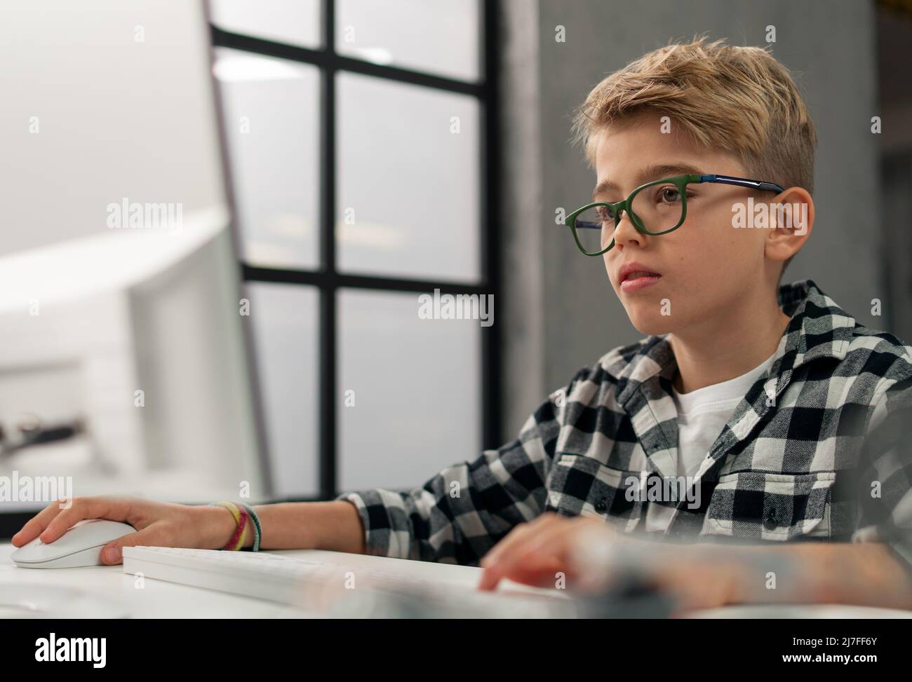 Scolaro che usa il computer in classe a scuola Foto Stock