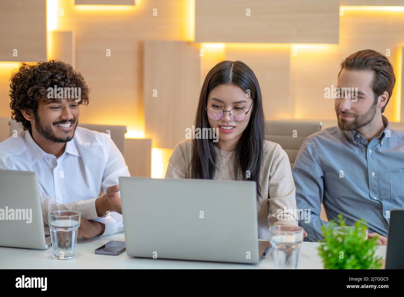 Tre dipendenti dell'ufficio che lavorano insieme per un progetto Foto Stock