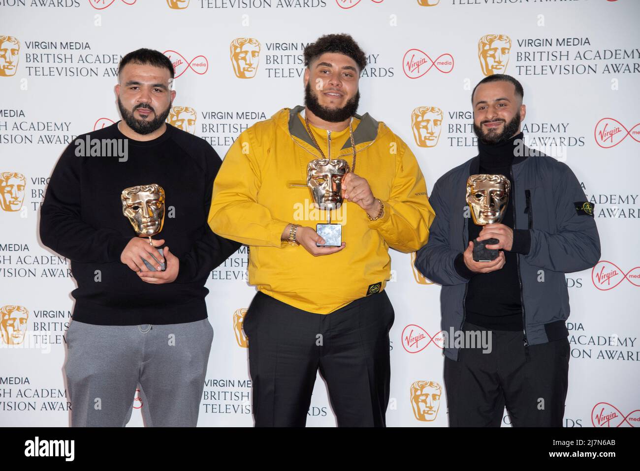 :(L-R) Tubsey, Big Zuu e Hyder, vincitori del premio Features per "Big Zuu's Big Eats", posa nella stanza del vincitore al Virgin Media British Acade Foto Stock