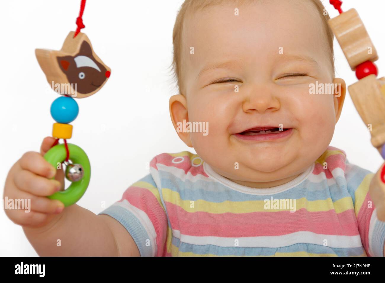 Un bambino carino ride mentre gioca Foto Stock