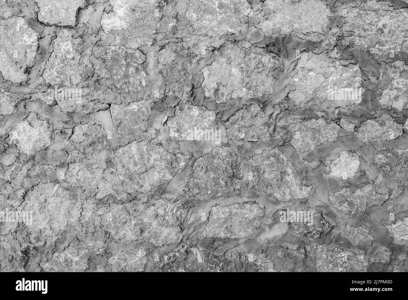 Antico muro di pietra sfondo con cemento. Foto Stock