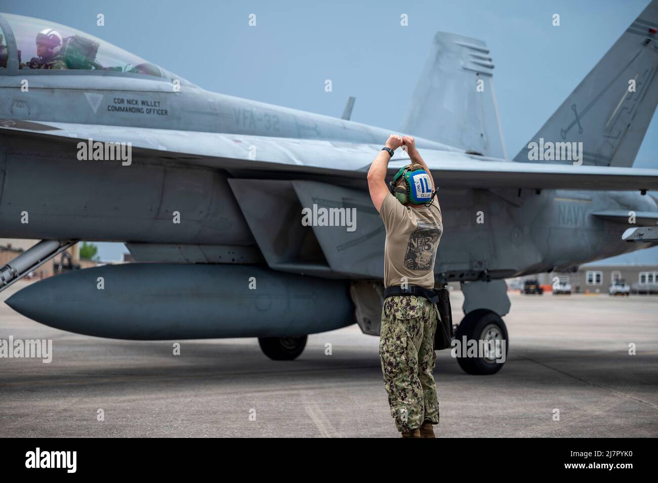 Un Sailor degli Stati Uniti segnala un pilota F/A-18 Super Hornet con Strike Fighter Squadron (VFA-32), Naval Air Station Oceana, Virginia, in luogo dopo l'arrivo per la bandiera a scacchi 22-2 alla base dell'aeronautica di Tyndall, Florida, 6 maggio 2022. Chequered Flag è un'esercitazione aerea a grande forza che si tiene a Tyndall e che favorisce la prontezza e l'interoperabilità attraverso l'incorporazione di velivoli di 4th e 5th generazioni durante l'addestramento di combattimento aria-aria. L'iterazione del 22-2 dell'esercizio si è svolta dal 9 al 20 maggio 2022. (STATI UNITI Air Force foto di Airman 1st classe Tiffany del Oso) Foto Stock