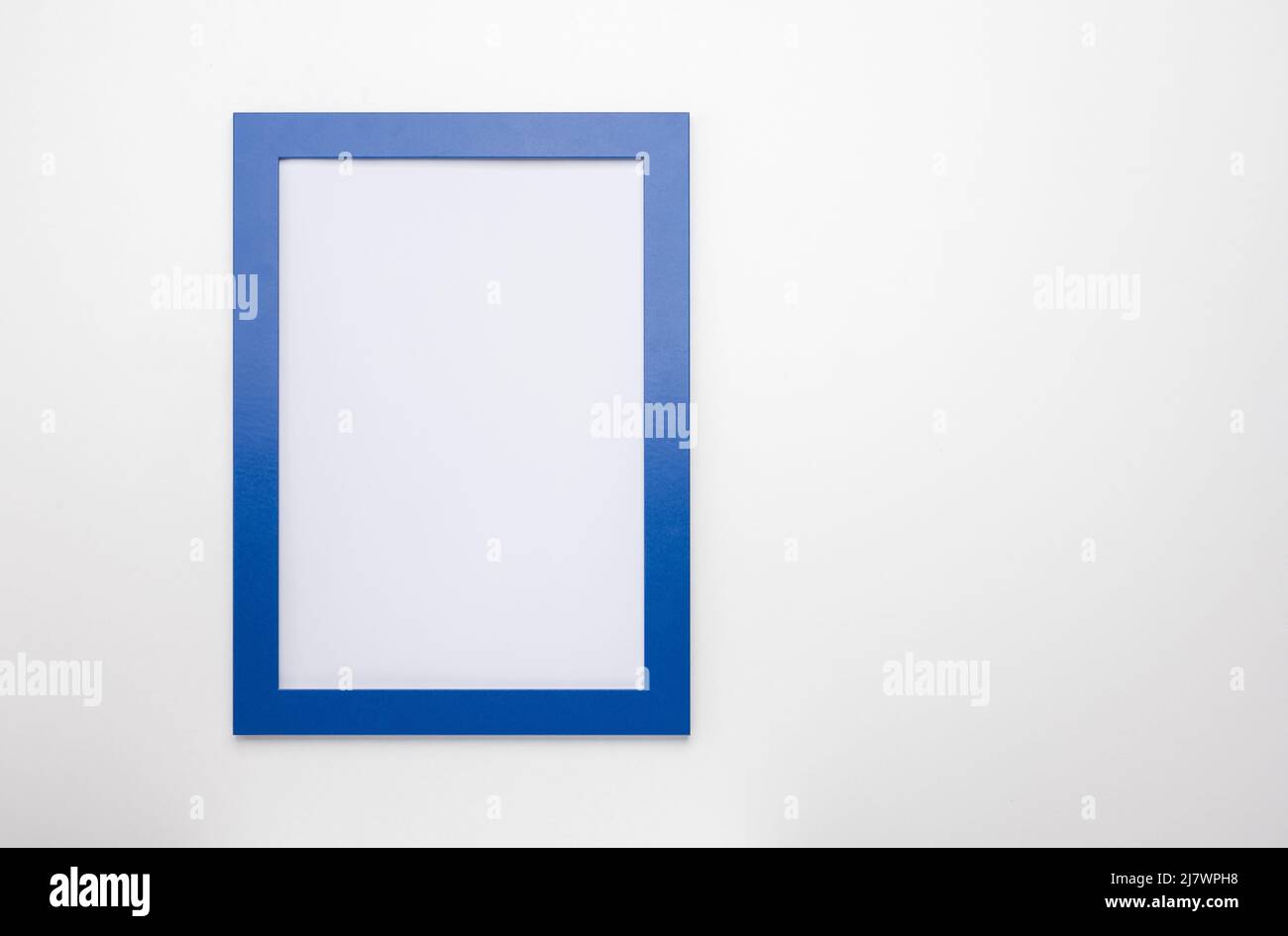 cornice fotografica verticale mockup su parete bianca. cornice diploma vuota su sfondo bianco. Cornice mockup. Bianco cornice diploma su parete bianca retro gr Foto Stock