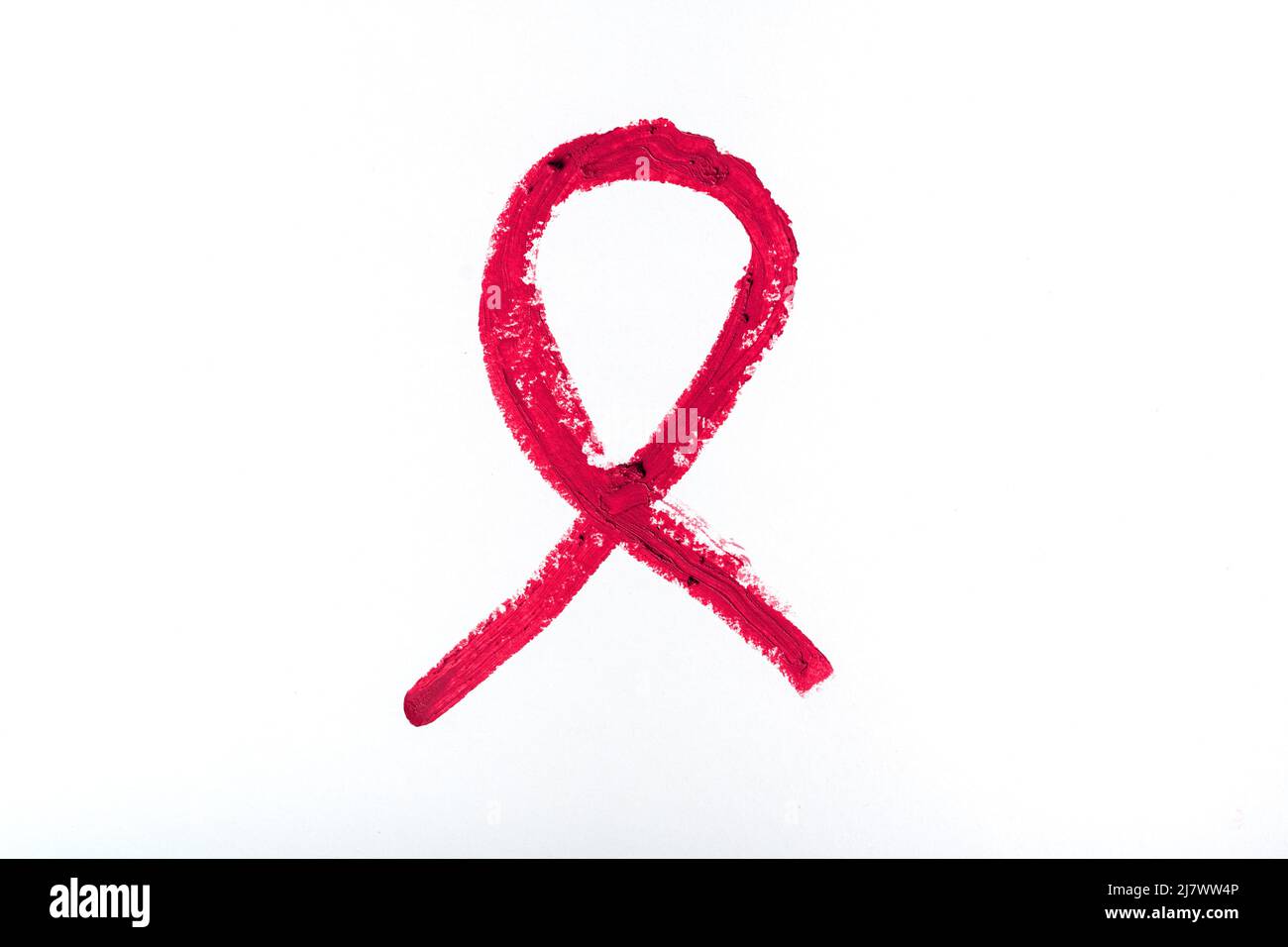 Rossetto rosso come simbolo di solidarietà per le persone che vivono con HIV o AIDS su sfondo bianco. Concetto di Giornata Mondiale dell'AIDS. Foto Stock