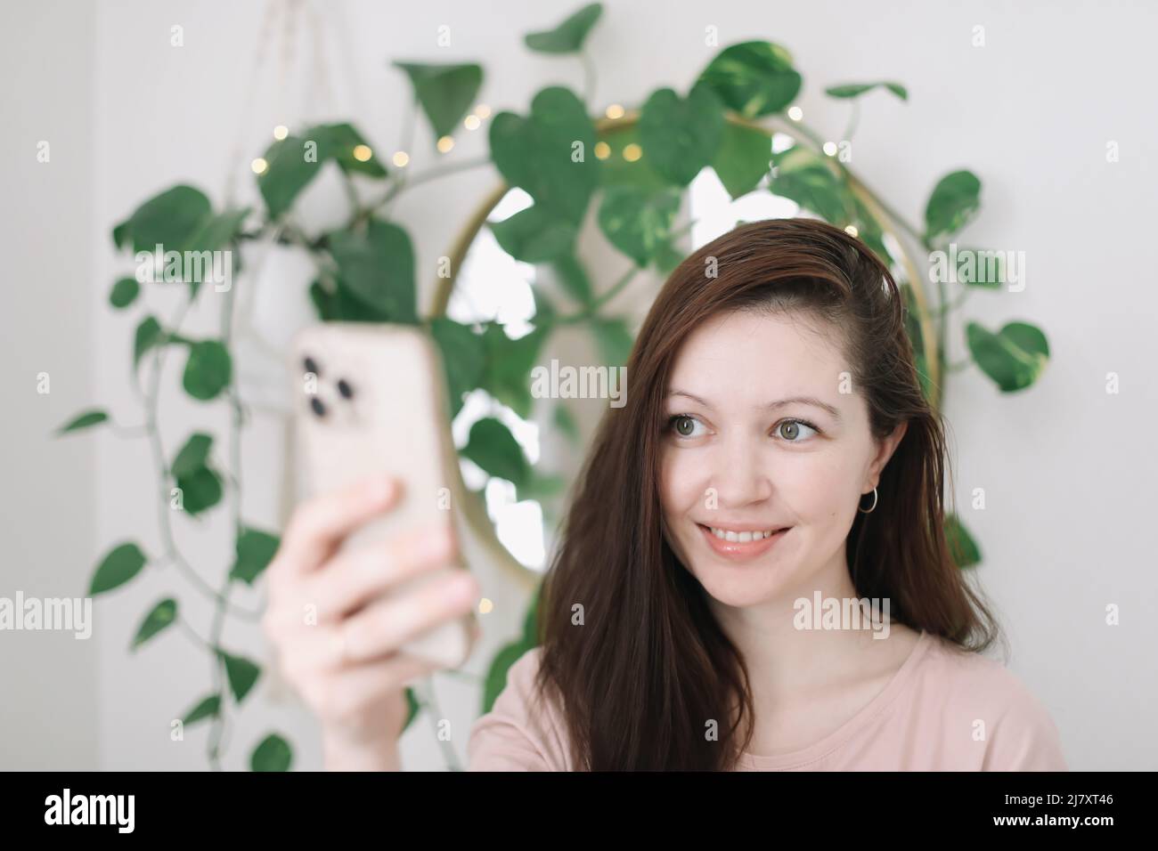 Ritratto di una donna casual sorridente con smartphone Foto Stock
