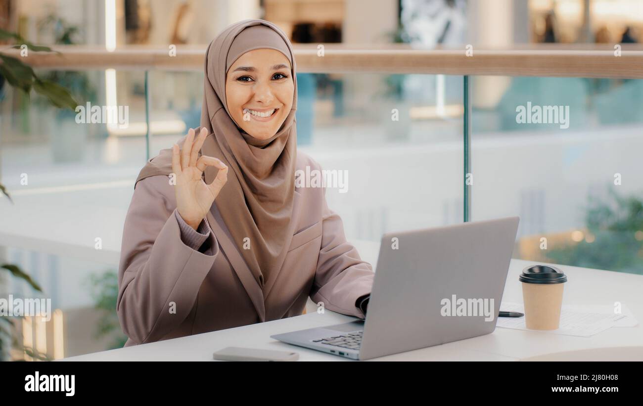 Fiducioso musulmana businesswoman freelancer nel lavoro hijab digitando su laptop chattare fa acquisti in negozio online ragazza studente studiare in remoto Foto Stock