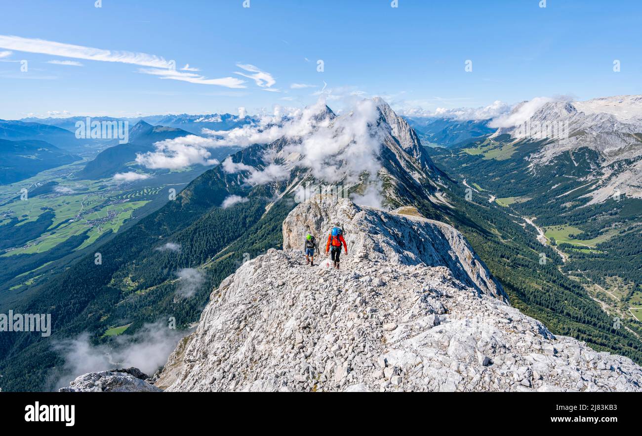 Due alpinisti sul crinale di Hohe Munde, dietro la cima Hochwand con Inntal e Leutasch valle, panorama montano con Wetterstein montagne Foto Stock