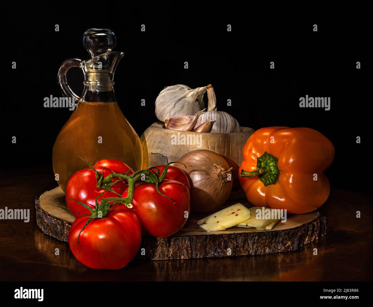 Olio d'oliva, verdure su pallet di legno. Pomodori, peperoni rossi e gialli, formaggio, cipolla e aglio composizione per stampa su tela. Foto Stock