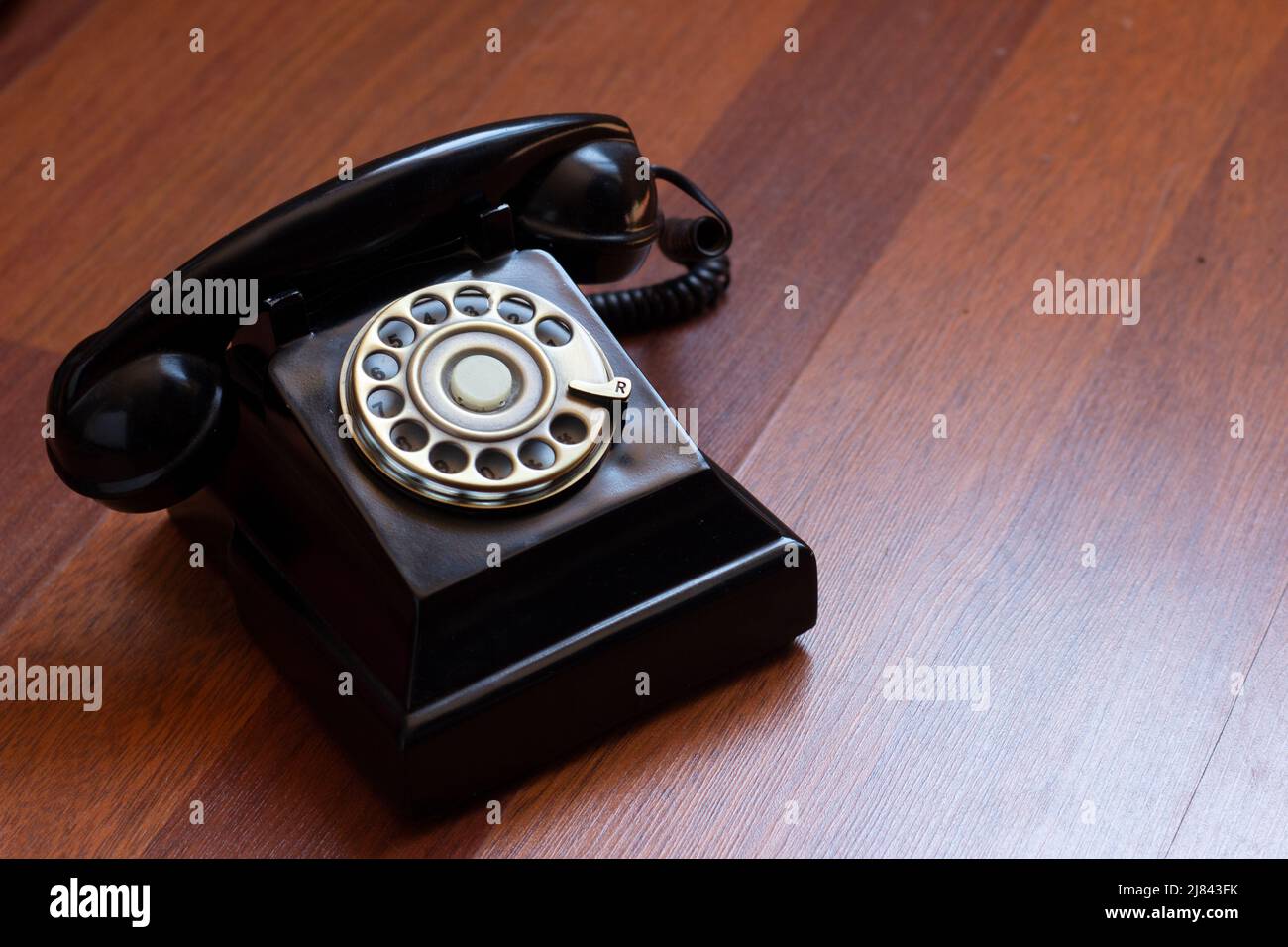 telefono analogico nero su legno rosso Foto Stock