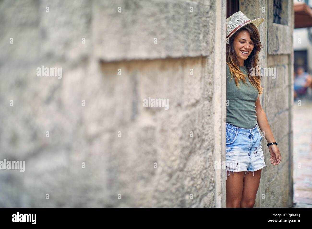Una giovane ragazza nella città vecchia in una bella giornata durante una vacanza sul mare. Vacanze, mare, turismo Foto Stock