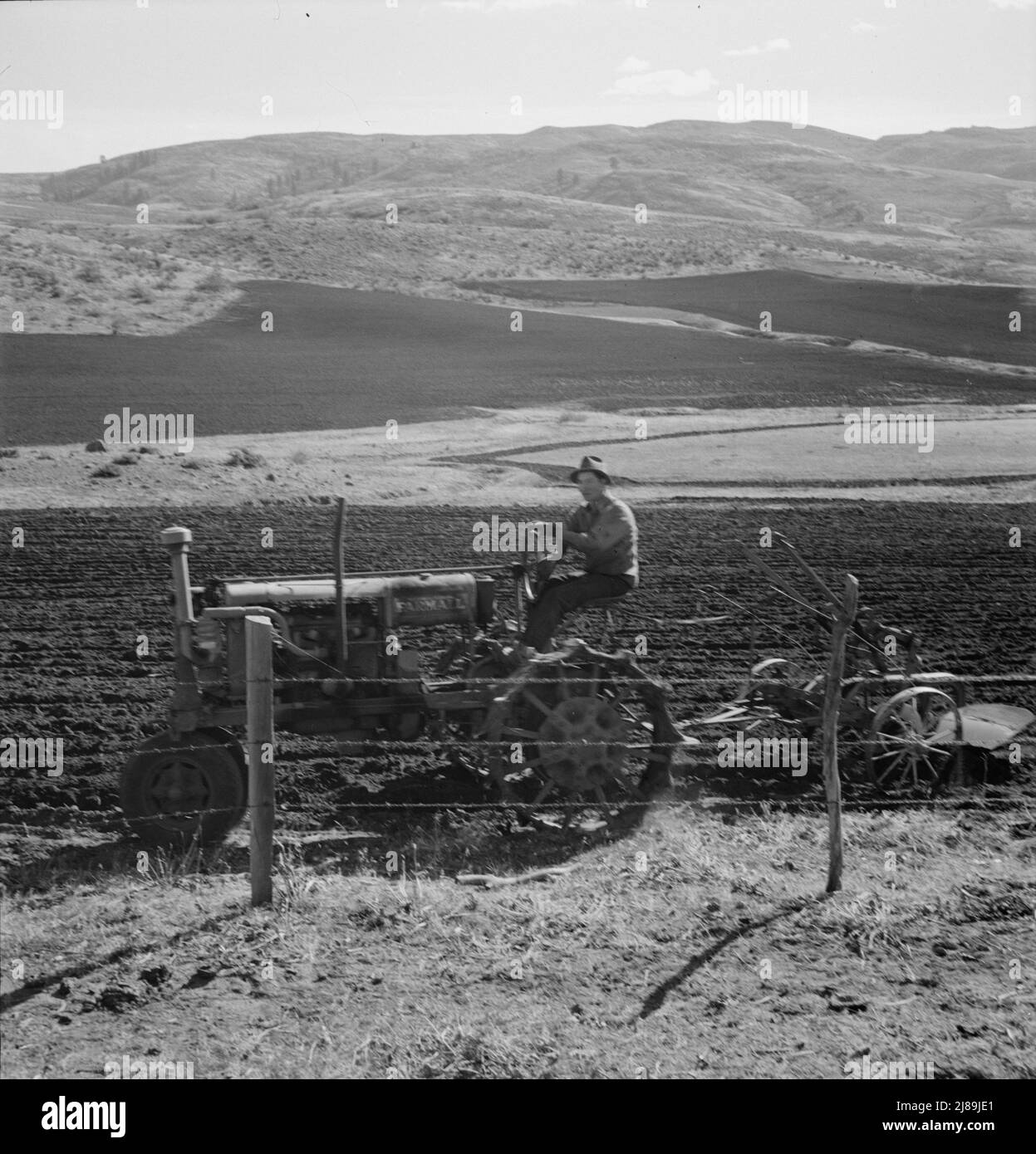 [Untitled, possible realted to: Giovane agricoltore Idaho che arava nell'autunno dell'anno mentre gli altri membri della cooperativa della segheria Ola self-help stanno lavorando nella segheria. Il trattore funziona per cinque famiglie di membri. GEM County, Idaho]. Foto Stock