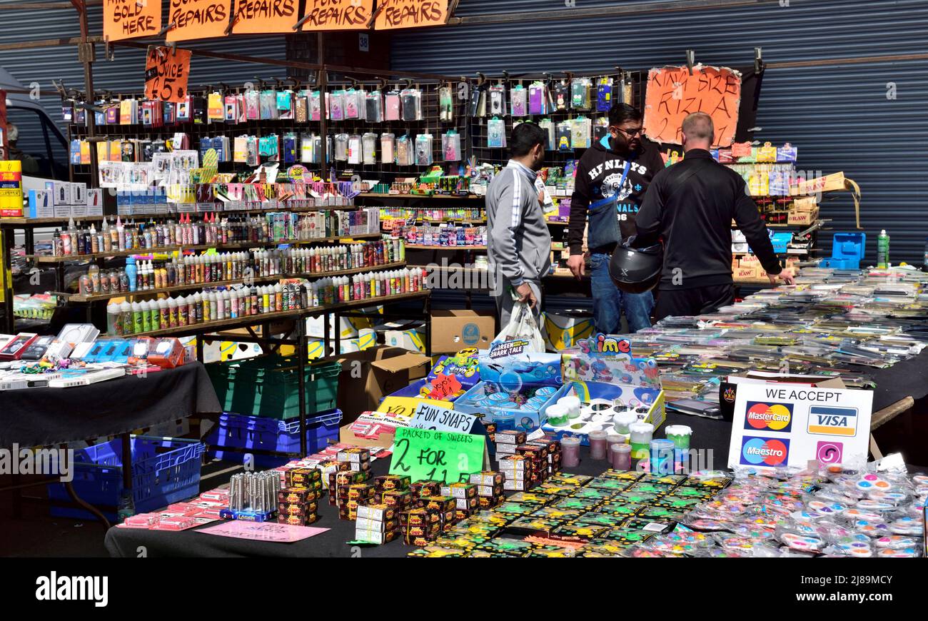 Bancarella di mercato con vari gadget, giocattoli, articoli per la casa in vendita al mercato Bristol Domenica Foto Stock