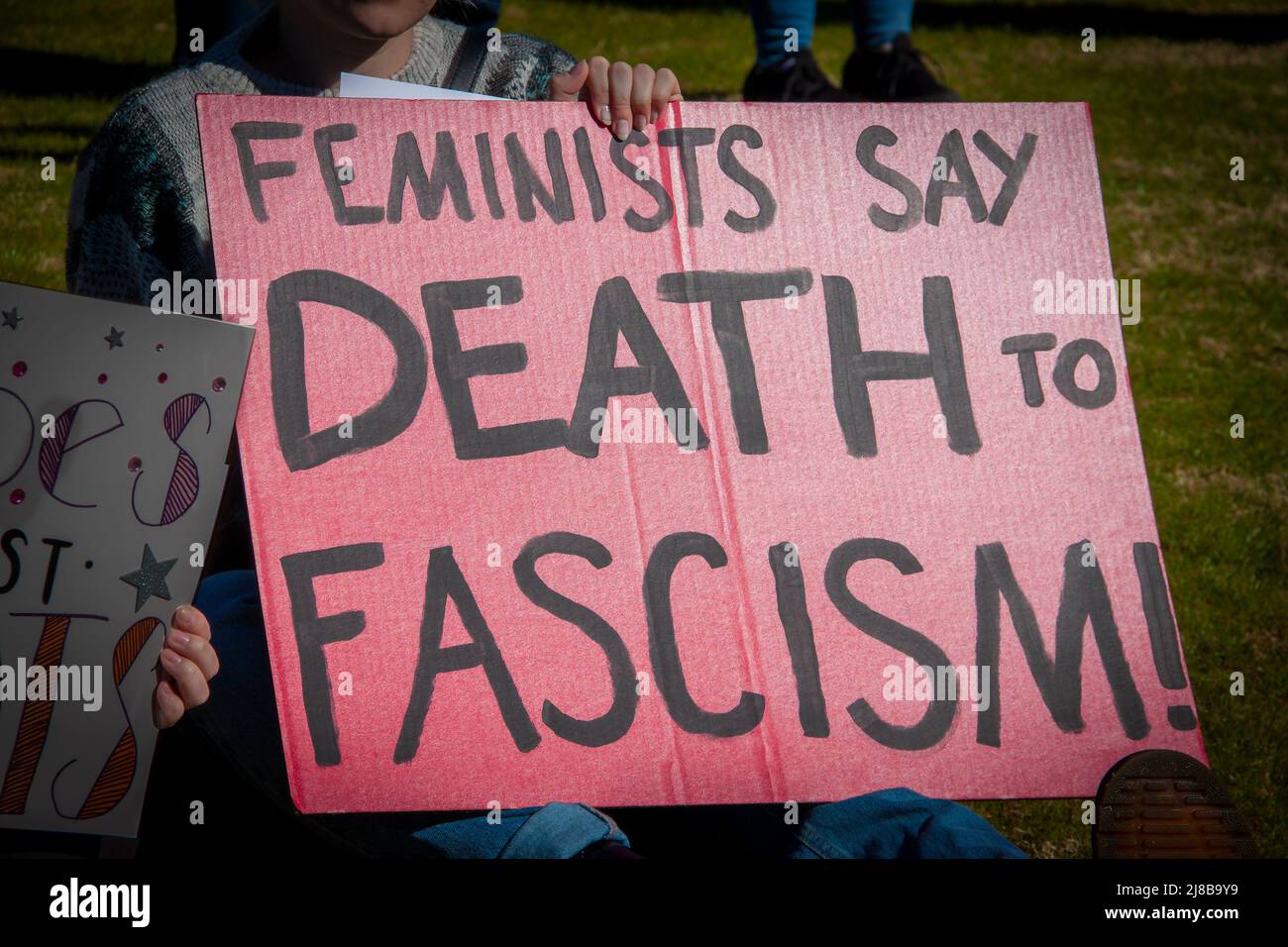 Segno di protesta fatto in casa - le femministe dicono la morte al fascismo - tenuto da una donna inidentificabile a marzo all'aperto Foto Stock