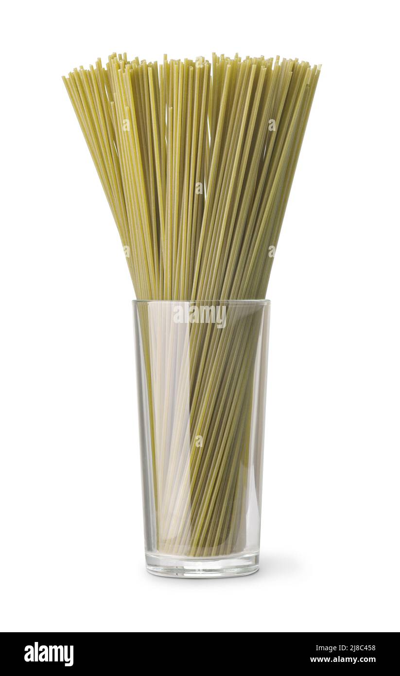 Vista frontale degli spaghetti di spinaci crudi verdi in vetro isolato su bianco Foto Stock