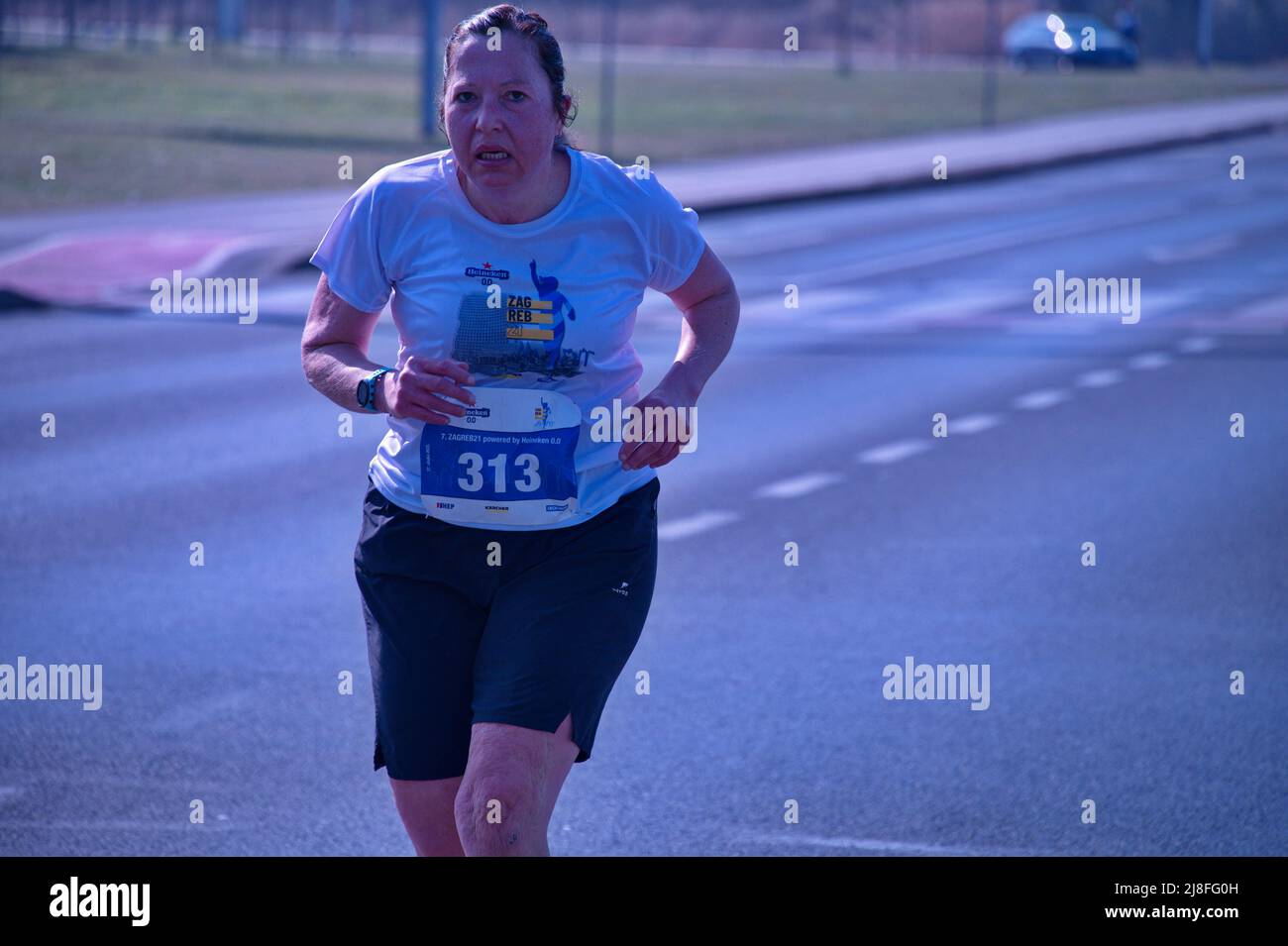 Ritratto di donna che corre maratona di strada Foto Stock