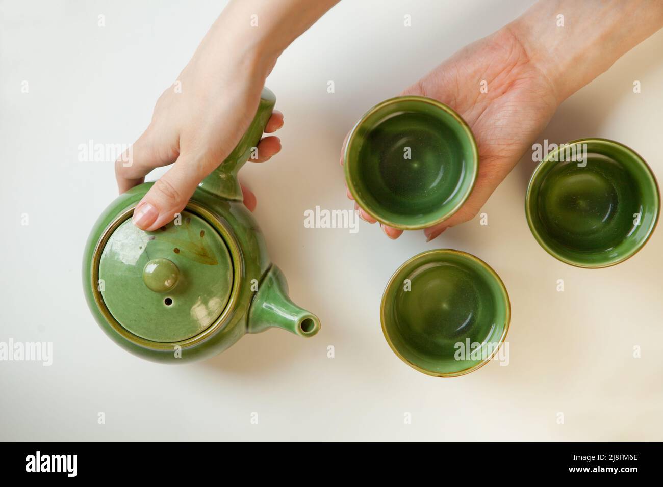 donna mani che tengono il tavolo da tè vista. tazza calda bevande salutari. lifestyle donna relax piatto Foto Stock