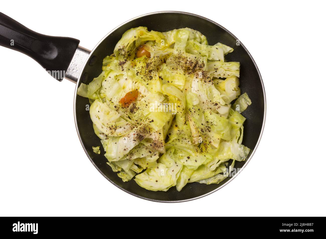 piatto di cavolo temperato in una padella, curry vegetale con pomodori e polvere di semi neri cosparsi sulla parte superiore, piatto vegetariano di cottura isolato su bianco Foto Stock