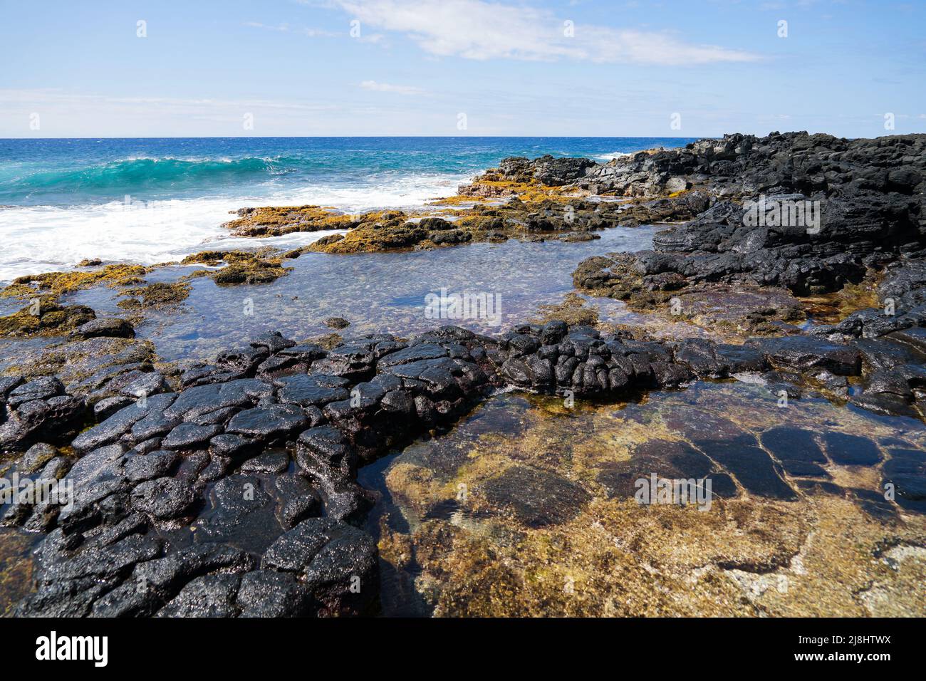 Piscine di marea su roccia lavica vulcanica articolata colonnare nel South Point Park, il punto più meridionale degli Stati Uniti sulla Big Island delle Hawaii in Foto Stock