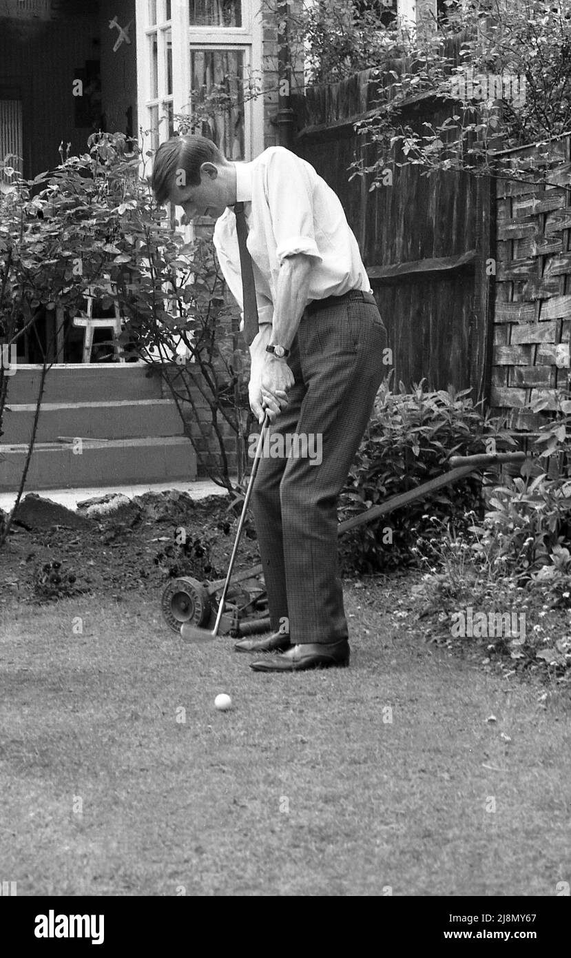 1970s, storico, un uomo che mette nel suo giardino posteriore, Inghilterra, Regno Unito. Foto Stock