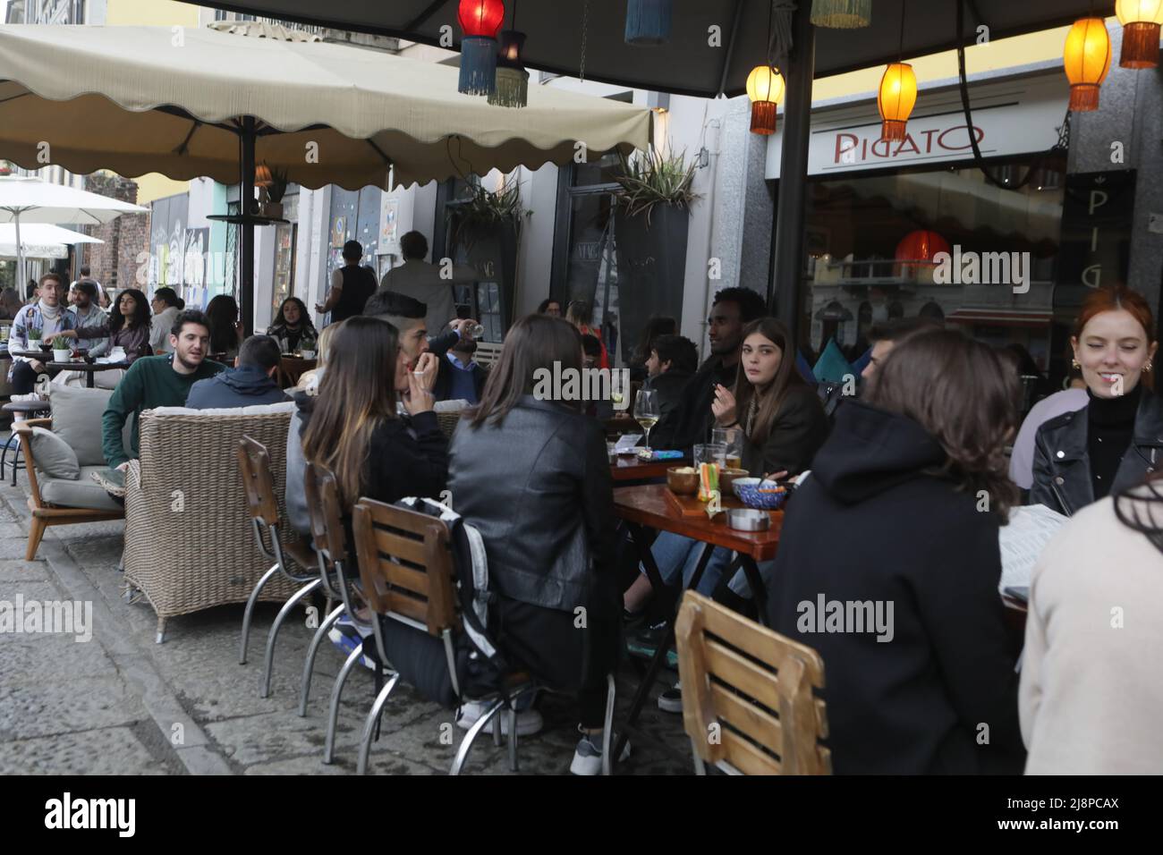 La gente ha un drink su una terrazza bar ai Navigli nel centro di Milano il 26 aprile 2021 come bar, ristoranti, cinema e sale da concerto parzialmente riaprono in tutta Italia in una spinta per le aziende di successo coronavirus caratterizzato da: Atmosfera dove: Milano, Italia quando: 26 apr 2021 credito: Mairo Cinquetti/WENN Foto Stock