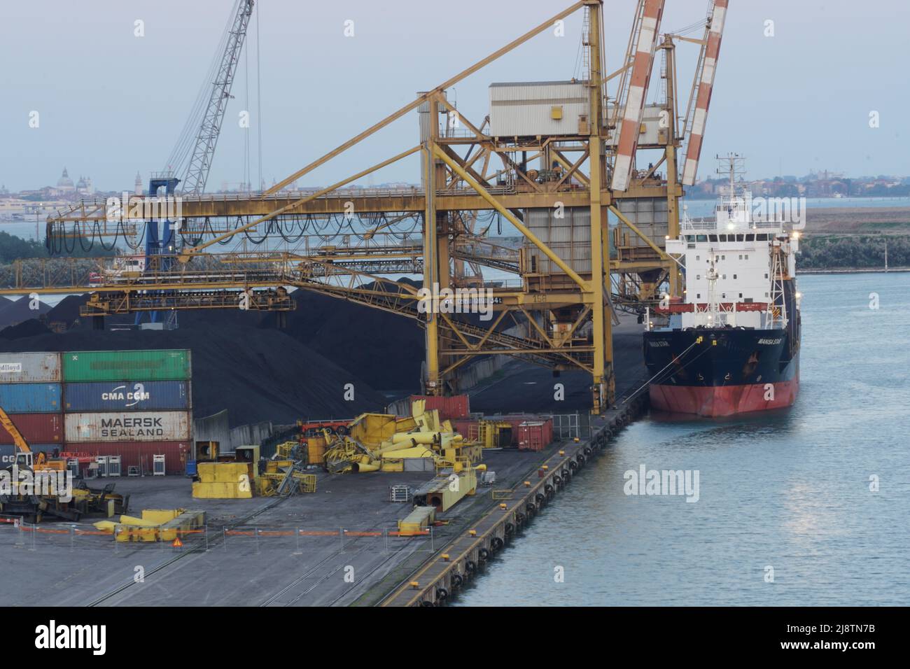 Nave da carico alla rinfusa ormeggiata nel terminal carbone del porto di Venezia con gru a portale per carico. Foto Stock